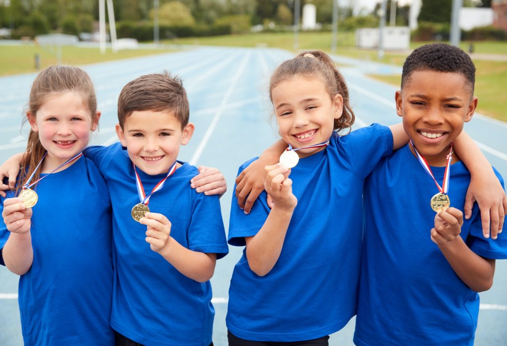 portrait-of-children-showing-off-winners-medals-on-sports-day.jpg